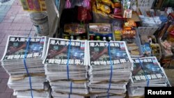 Copies of the final edition of Apple Daily, published by Next Digital, are seen at a newsstand in Hong Kong, China, June 24, 2021.