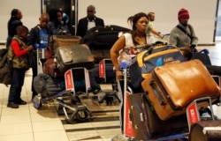 Nigerians queue at passport control at the O.R. Tambo International Airport in Johannesburg, South Africa, Sept. 11, 2019.