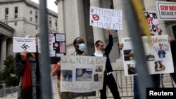 FILE - People protest against New York City-mandated vaccines against COVID-19, in front of the U.S. Courthouse in Manhattan, New York, Oct. 12, 2021.