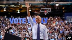 President Barack Obama waves to supporters at Florida International University in Miami, Nov. 3, 2016, during a campaign rally for Democratic presidential candidate Hillary Clinton. 