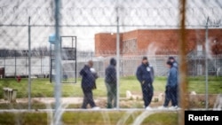 FILE - Inmates exercise in the yard at the Marion Correctional Institution, where there have been positive cases of the coronavirus disease, in Marion, Ohio, April 22, 2020. 