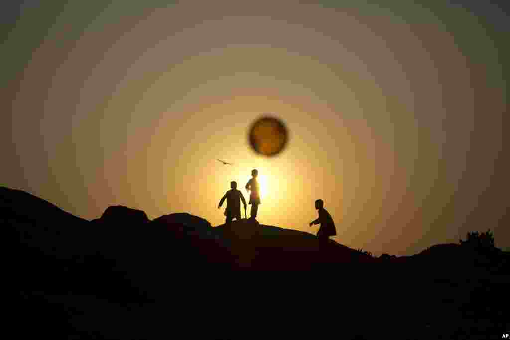 Afghan refugee children chase a balloon on the outskirts of Islamabad, Pakistan.