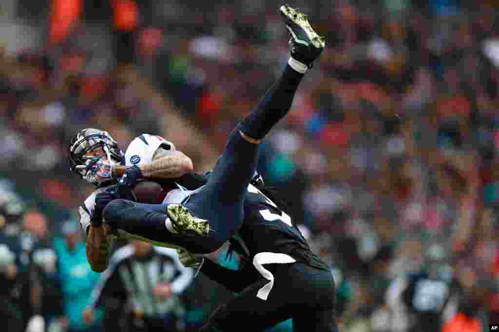 Jacksonville Jaguars cornerback Tre Herndon (37) hits Houston Texans wide receiver Kenny Stills (12) during the first half of an NFL football game at Wembley Stadium in London.