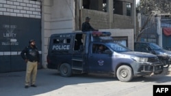 Pakistan police officers stand guard outside a factory where two Chinese nationals were shot, in Karachi on Nov. 5, 2024.