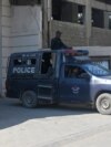 Pakistan police officers stand guard outside a factory where two Chinese nationals were shot, in Karachi on Nov. 5, 2024.