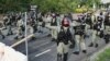 Petugas polisi anti huru-hara berpatroli di jalan selama protes anti-pemerintah di distrik Tai Po, di Hong Kong, Cina, 13 Oktober 2019. (Foto: Reuters/Ammar Awad)