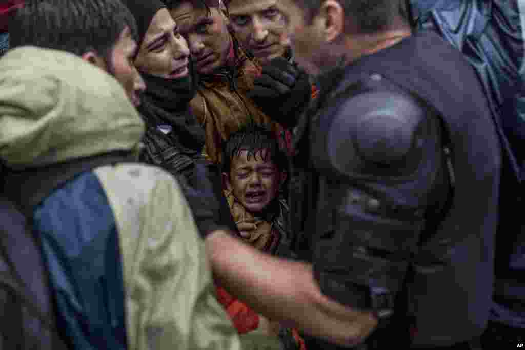 A Syrian refugee boy cries while he and his family try to board a train at the station in Tovarnik, Croatia. Police said more people are coming in from Serbia, mostly near the eastern border town of Tovarnik, where there are already around 2,500 people waiting for transport.