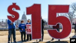 Activists appeal for a $15 minimum wage near the Capitol in Washington, Thursday, Feb. 25, 2021. 
