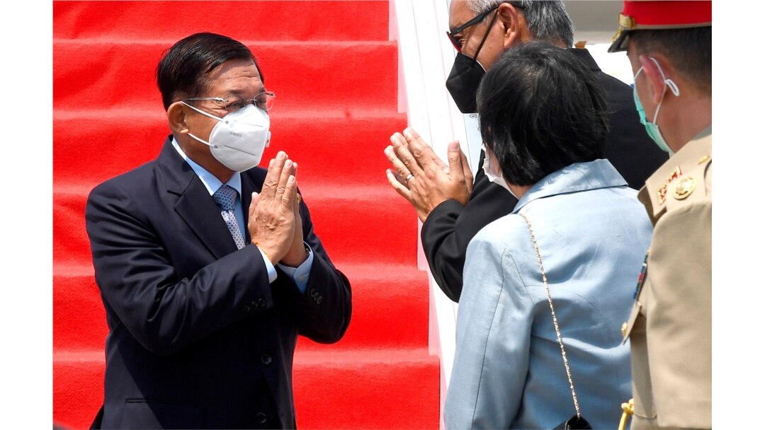 In this photo released by Indonesian Presidential Palace, Myanmar's Senior General Min Aung Hlaing, left, is greeted by an unidentified Indonesian official upon arrival at Soekarno-Hatta International Airport in Indonesia, April 24, 2021.