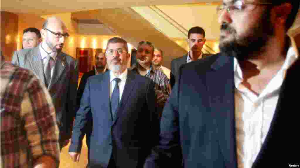 Mohamed Morsi arrives to give a news conference Friday afternoon.