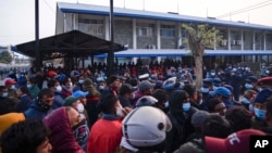 People crowd outside a hospital for news after a passenger plane crashed in Pokhara, Nepal, Jan. 15, 2023.