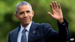 FILE - President Barack Obama waves as he walks across the South Lawn of the White House, in Washington, as he returns from Charlotte, N.C. where he participated in a campaign event with Democratic presidential candidate Hillary Clinton, July 5, 2016.
