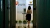 FILE - A woman enters an office of GlaxoSimthKline in Beijing, China.