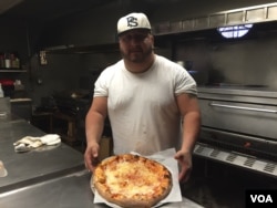 Marty Coar Jr., who runs Two Brothers Pizza in Dunmore, Pennsylvania, made news during Democratic presidential candidate Hillary Clinton's last visit when he made what he called a "Madam President" pizza topped with hot sauce. (A. Pande/VOA)