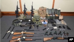 FILE - This image provided by the U.S. District Court in Maryland shows a photo of firearms and ammunition that was in the motion for detention pending trial in the case against Christopher Paul Hasson. 