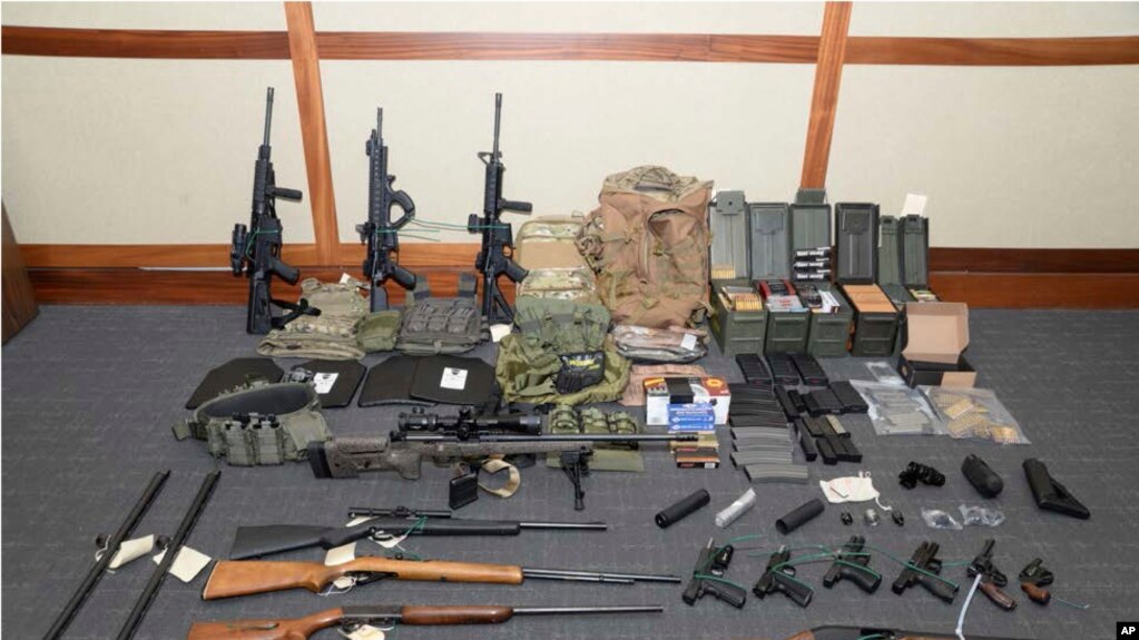 This image provided by the U.S. District Court in Maryland shows a photo of firearms and ammunition that was in the motion for detention pending trial in the case against Christopher Paul Hasson, whom prosecutors call a "domestic terrorist." 