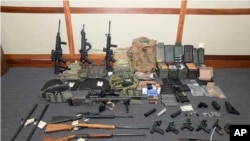 This image provided by the U.S. District Court in Maryland shows a photo of firearms and ammunition that was in the motion for detention pending trial in the case against Christopher Paul Hasson. 