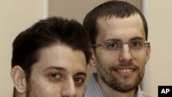 In this photo released by the Islamic Republic News Agency, IRNA, on Wednesday, September 21, 2011, US hikers Shane Bauer, right, and Josh Fattal, smile, at the Tehran's Mehrabad airport before leaving Iran.