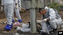 Israeli police explosives experts survey the scene of an explosion near a bus stop in a Jewish district of Jerusalem, March 23, 2011