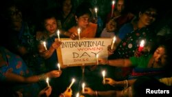 FILE - Sex workers hold candles during a rally to mark International Women's Day inside a brothel in the northeastern Indian city of Siliguri, March 8, 2008.