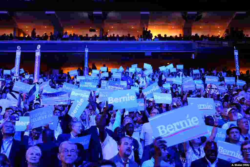 Crowds hold Bernie Sanders signs at the Democratic National Convention in Philadelphia July 25, 2016 (A. Shaker/VOA)