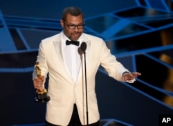 FILE - Jordan Peele accepts the award for best original screenplay for "Get Out" at the Oscars at the Dolby Theatre in Los Angeles, March 4, 2018.