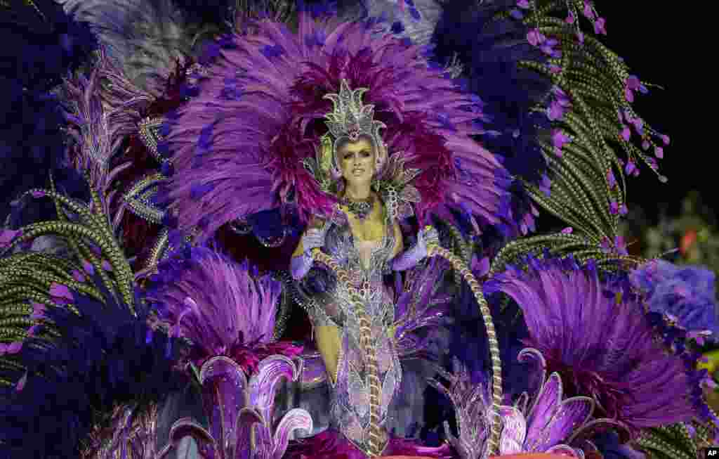 A dancer from the Mocidade Alegre samba school performs on a float during a carnival parade in Sao Paulo, Brazil.