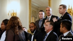 Marjory Stoneman Douglas High School parent Andrew Pollack, with his sons, talks about the death of his daughter Meadow as President Donald Trump hosts a listening session with school shooting survivors and students at the White House in Washington, Feb. 21, 2018.