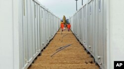 Workers walk between container houses on the Turkish-Syrian border in the southeastern city of Kilis, Turkey, February 2012. (file photo)