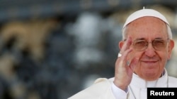 FILE - Pope Francis waves as he leads the weekly audience in Saint Peter's Square, April 10, 2013.