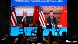 A screen shows Chinese President Xi Jinping attending a virtual meeting with U.S. President Joe Biden via video link, at a restaurant in Beijing, China, November 16, 2021.