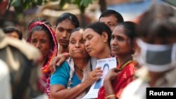 Relatives mourn as they look for a garment worker, who is missing after the collapse of the Rana Plaza building in Savar, outside Dhaka, May 2, 2013. 