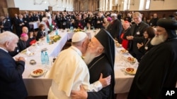 Pope Francis hugs Orthodox Ecumenical Patriarch Bartholomew I, during an interfaith day of prayer for peace, in Assisi, Italy, Sept. 20, 2016.