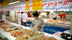 A woman shops for chicken at a supermarket in Beijing, May 12, 2017. China will finally open its borders to U.S. beef while cooked Chinese poultry is closer to hitting the American market as part of a U.S.-China trade agreement. 