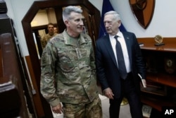 FILE - U.S. Defense Secretary James Mattis, right, and U.S. Army General John Nicholson, commander of U.S. Forces Afghanistan, arrive to meet with an Afghan defense delegation at Resolute Support headquarters, in Kabul Afghanistan, April 24, 2017.