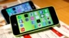 FILE - These then-new Apple iPhone 5c models were on display in at Tokyo store on Sept. 20, 2013. A 5c is at the center of Apple's battle with the FBI over efforts to break the company's proprietary auto-destruct security system. 