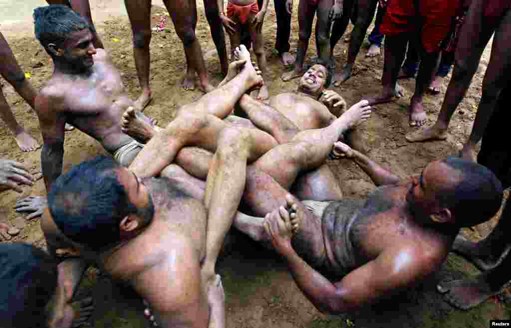 Wrestlers practice at a traditional Indian wrestling training center in Allahabad, India.