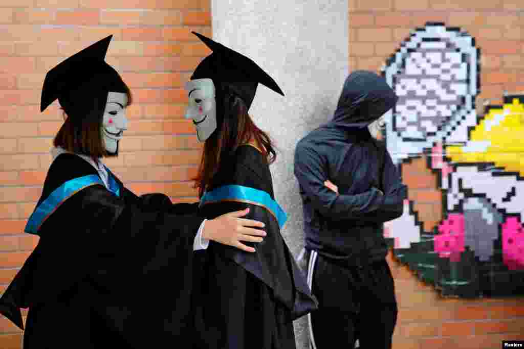 University students wear Guy Fawkes masks for a photoshoot of a graduation ceremony to support anti-government protests at the Hong Kong Polytechnic University, in Hong Kong, China.
