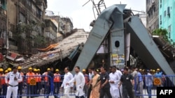 Rahul Gandhi, center left, vice president of the Indian National Congress Party, and Adhir Ranjan Chowdhury, center second left, state president of the West Bengal Pradesh Congress Committee, visit the site of a collapsed bridge in Kolkata, April 2, 2016.