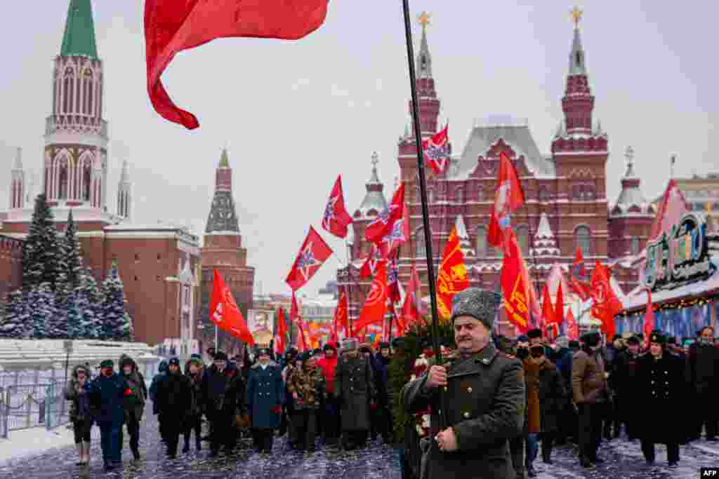 Russian Communist party supporters march to lay flowers at the tomb of late Soviet leader Joseph Stalin during a memorial ceremony to mark the 142nd anniversary of his birth at Red Square in Moscow.