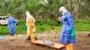 In this photo taken on Friday, June 19, 2015, the wrapped remains of a new born child suspected of contracting the Ebola virus, lays on a stretcher as health workers, dressed in Ebola protective gear, move the body for burial in Dubreka, Guinea. Despite hopes that the deadly Ebola outbreak could soon be contained in West Africa, it shows no signs of abating in Guinea and may be flaring up once more in Sierra Leone as people are flouting rules limiting travel meant to stop it. (AP Photo/Youssouf Bah)