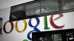 FILE - Passengers look through windows on a bus painted with an advertisement for Google in Beijing, China.