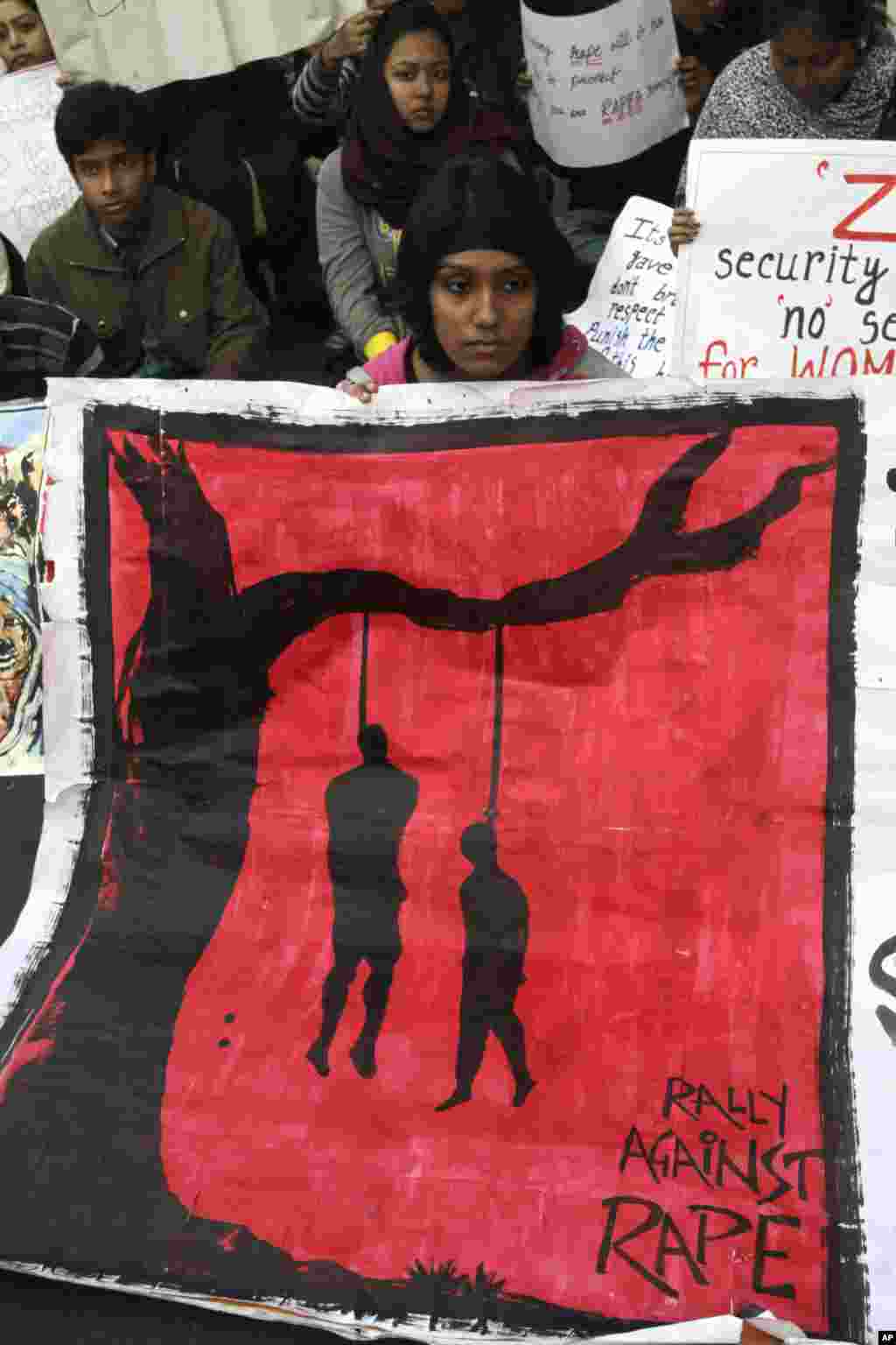 Indians protesting the recent gang-rape of a young woman in a moving bus in New Delhi, display a poster calling for death penalty for offenders at a rally in Kolkata, December 27, 2012.