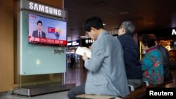 FILE - People watch a TV broadcasting a news report on North Korea's failed missile launch from its east coast, at a railway station in Seoul, South Korea, April 16, 2017.
