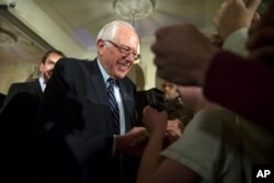 Democratic presidential candidate Sen. Bernie Sanders, I-Vt., shakes hands during a campaign rally in Davenport, Iowa, Jan. 29, 2016.