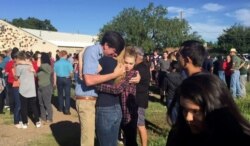 FILE: In this image made from a video by KWES-TV, people gather near the Alpine High School school campus after a shooting, in Alpine, Texas, Thursday, Sept. 8, 2016.