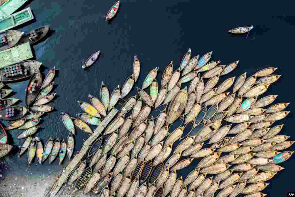 An aerial picture shows boatmen waiting for passengers docked on the bank of a river in Dhaka, Bangladesh, March 28, 2020