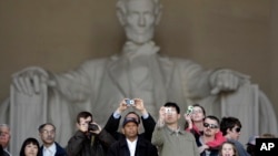 People visit the Lincoln Memorial in Washington Sunday, April 12, 2009. (AP Photo/Alex Brandon)