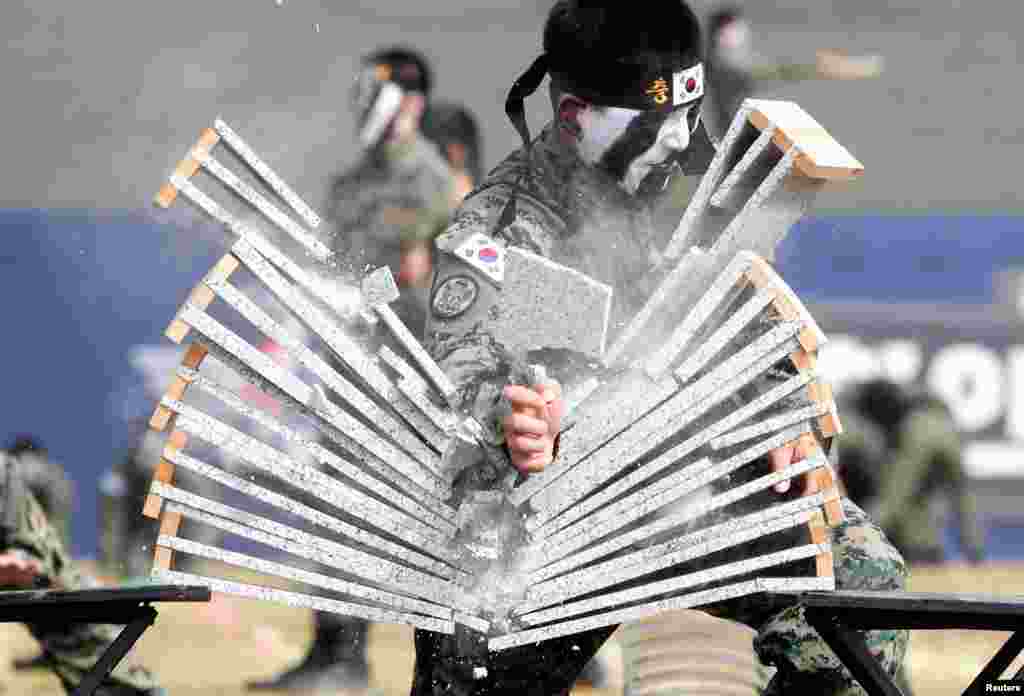 Members of the Special Warfare Command give a demonstration of their skills in the traditional Korean martial art of taekwondo ahead of a celebration to mark the 69th anniversary of Korea Armed Forces Day, in Pyeongtaek, South Korea.
