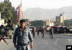 Description: Afghan security police stand guard near the site of a deadly suicide attack outside a cricket stadium, in Kabul, Afghanistan, Sept. 13, 2017.